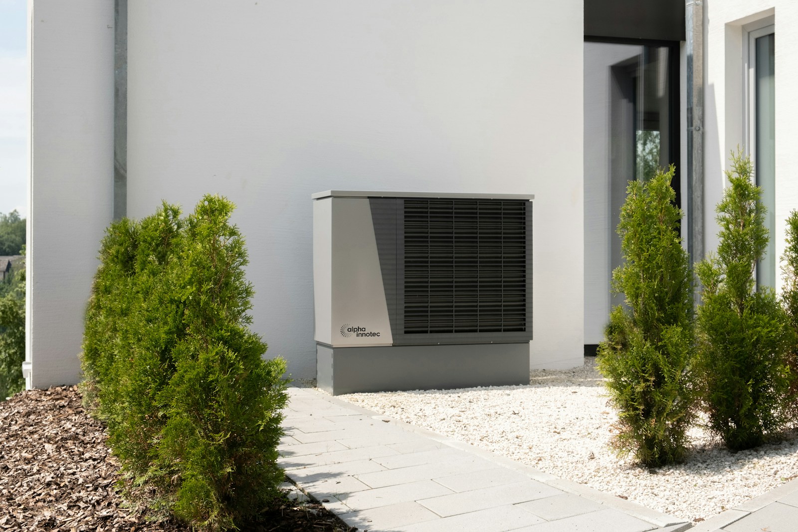 Air source heat pump installed on a house wall